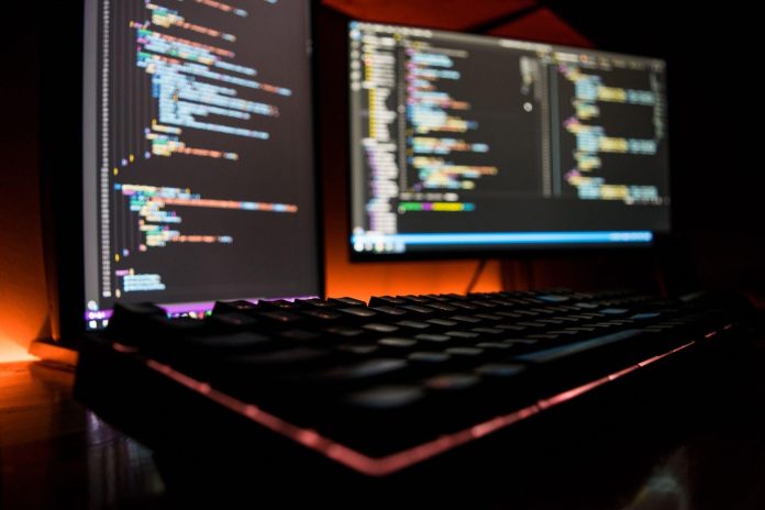 A computer with LED keyboard and code illuminates ThriveDX’s cybersecurity bootcamps